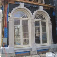 Decorative cut stone window frame for facade of luxury residential house with stone window surround